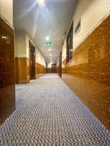 an empty hallway of a building with a tile floor at TAMARIND HOTEL in Dubai