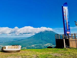 a bed on a hill with a mountain in the background at TORIFITO HOTEL&POD NISEKO - Vacation STAY 81528v in Kutchan