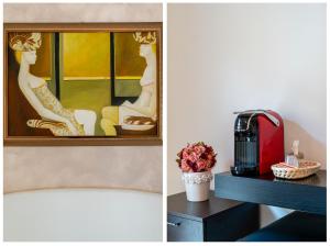 a room with a coffee maker and a picture of two women at MARCANTONIO ROOM Ampia camera con bagno privato e self check in in Perugia