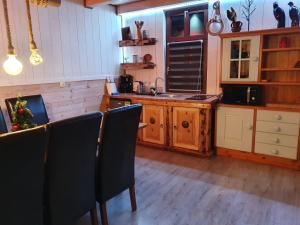 a kitchen with a table and some chairs in it at Sloneczna Osada 2 in Kowary
