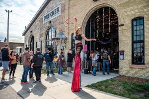 a woman is standing on a street with a racket at Brewhalla Hotel in Fargo