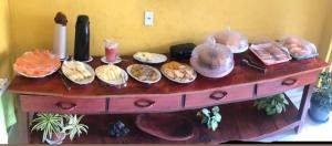 a table with many different types of food on it at Pousada Recanto da Vila in Trancoso
