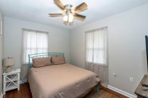 a bedroom with a bed and a ceiling fan at 3 Minute Drive to the Airport in Maryville