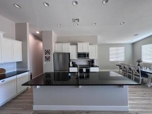 a kitchen with a black counter top in a room at Desert Gem - Mesquite in Mesquite