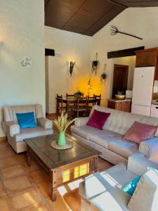 a living room with two couches and a coffee table at Complejo Rural Mirador de la Alcaidía in Hornachuelos