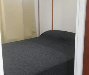 a bed in a room with a closet at Cabaña 3 in Bialet Massé