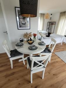 a white table and chairs in a living room at Ferienwohnung Nachtigall 2 in Bad Hersfeld +16 photos