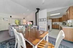 a kitchen and dining room with a wooden table and chairs at Coral Cottage MCA#832 in Manzanita