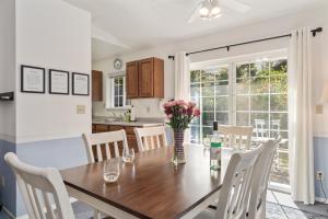 a kitchen and dining room with a wooden table and chairs at Coral Cottage MCA#832 in Manzanita +13 photos