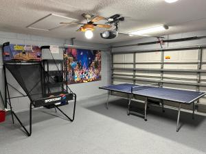 a room with a ping pong table in a garage at Beautiful Waterfront Home with Heated Pool and Game Room in Davenport