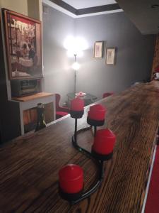 a room with a table and red stools at Skitnica Red door in Koprivnica