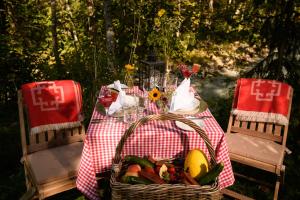 a picnic table with a basket of food on it at House of Hütter - Wachtelhof Hotel & Spa in Maria Alm am Steinernen Meer