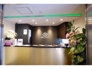 a lobby with a counter with flowers on it at Tabata Oji Hotel - Vacation STAY 89839v in Tokyo