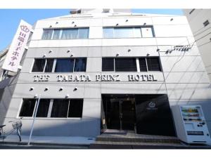 a white building with the entrance to theza party hotel at Tabata Oji Hotel - Vacation STAY 89854v in Tokyo