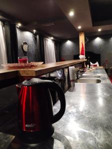 a red tea kettle sitting on a counter in a kitchen at Skitnica Red door in Koprivnica