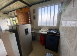 a small kitchen with a refrigerator and a stove at Mirador La Colina in San Francisco