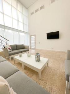 sala de estar con sofá y mesa de centro en Exclusiva casa en Baru con piscina y playa privada en Playa Blanca