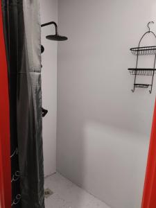 a room with a black curtain and a white wall at Skitnica Red door in Koprivnica