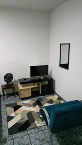 sala de estar con TV y sofá en Apartamento aconchegante em Cacoal4, en Cacoal