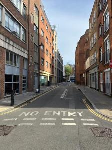 an empty street with no entry written on the road at Farringdon Apartments in London