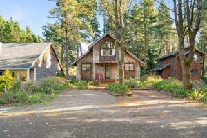 a home in the woods with a driveway at Sea Dream MCA#398 in Manzanita