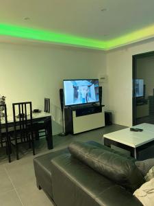 a living room with a couch and a flat screen tv at Love room in Mondragon +21 photos