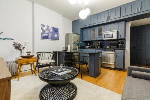 a kitchen and living room with a table and chairs at Apartment 282: Columbus Circle in New York