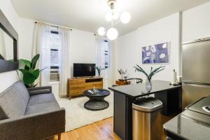 a living room with a couch and a table at Apartment 282: Columbus Circle in New York