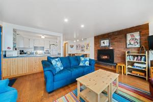 a living room with a blue couch and a table at Neahkahnie MCA#50060 in Manzanita