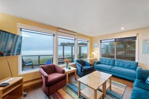 a living room with a blue couch and chairs at Neahkahnie MCA#50060 in Manzanita