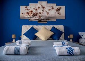 a blue bedroom with a bed with blue walls at Blu Mare Lampedusa Bed And Breakfast in Lampedusa