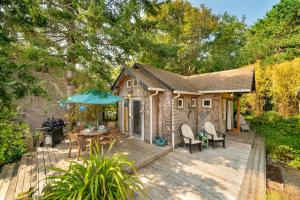 a wooden deck with a table and an umbrella at Lil Love Shack in Manzanita