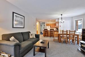 a living room with a couch and a table at Beautifully decorated 3 bedroom condo nestled Slopeside on Pico Mountain Ski-in Ski-out G101 in Killington