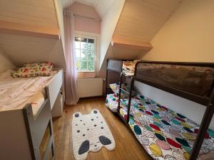a bedroom with two bunk beds and a window at Maison avec piscine, sauna, spa in Cepoy +13 photos