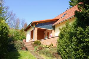 a house with a staircase leading to the door at Ferienhaus Harzblick in Güntersberge