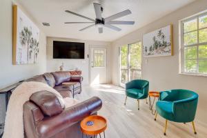 a living room with a leather couch and chairs at Dock and Game Room Canal-Front Spring Hill Home in Spring Hill