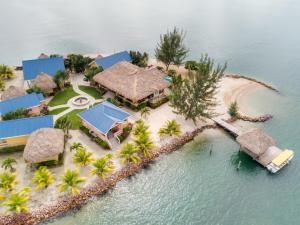 an aerial view of a resort on an island in the water at Little Harvest Caye - Your Own Private Island in Placencia Village