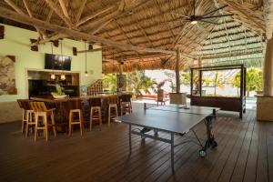 a kitchen and dining room with a table and chairs at Little Harvest Caye - Your Own Private Island in Placencia