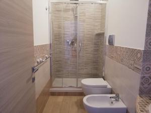 a bathroom with a shower and a toilet and a sink at Blu Mare Lampedusa Bed And Breakfast in Lampedusa