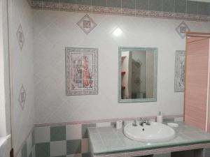 a bathroom with a sink and a mirror at Blu Mare Lampedusa Bed And Breakfast in Lampedusa