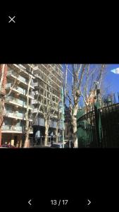 a picture of a building with a tree in front of it at Park City Buenos Aires in Buenos Aires