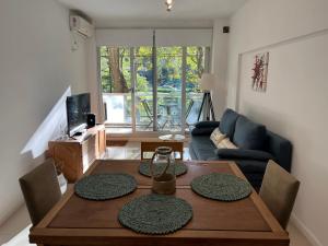 a living room with a wooden table and a couch at Park City Buenos Aires in Buenos Aires