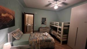 a bedroom with a bed and bunk beds in it at Paola House in Lonato del Garda