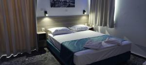 A bed or beds in a room at San Georgio Hotel