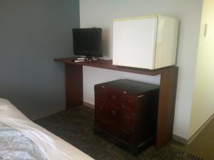 a bedroom with a bed and a desk with a television at Futtsu Sea House INN Kanaya - Vacation STAY 95628v in Futtsu