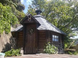 a small log cabin with a black roof at Futtsu Sea House INN Kanaya - Vacation STAY 95628v in Futtsu