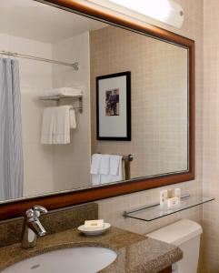 a bathroom with a sink and a large mirror at Courtyard by Marriott New York Manhattan/ Fifth Avenue in New York