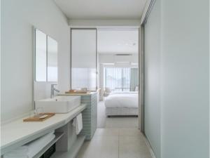 a bathroom with a sink and a bed at ITOMACHI HOTEL 0 - Vacation STAY 97646v in Saijo