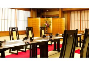 a row of tables with chairs in a room at Asanoya - Vacation STAY 01715v in Shinonsen +76 photos