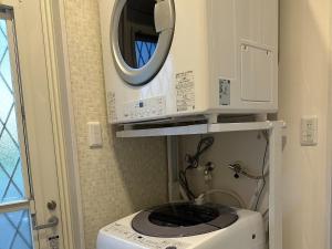eine Waschmaschine im Bad mit Spiegel in der Unterkunft Bears Stay Kumejima Villa - Vacation STAY 00998v in Kumejima